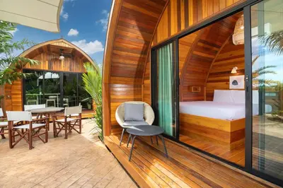 a room with a bed and a table and chairs at Tropical Chalet-Style 2BR Villa with Pool Pasak Paradise 2, Bangtao in Bang Tao Beach