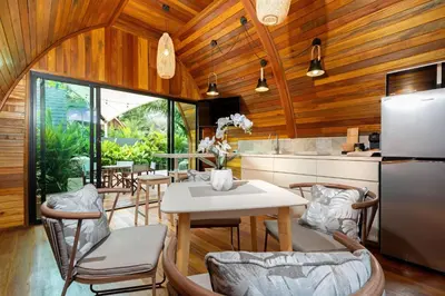 a kitchen with a table and chairs and a refrigerator at Tropical Chalet-Style 2BR Villa with Pool Pasak Paradise 2, Bangtao in Bang Tao Beach