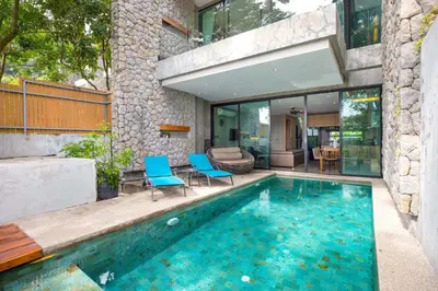 a swimming pool with blue chairs and a house at Private & Modern 4BR Pool Villa Otero, 3 Levels of Comfort with Greenery Views, Kamala in Kamala Beach