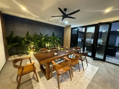 a dining room table with chairs and a ceiling fan at Luciana Villa by G Estate Phuket in Rawai Beach