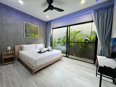 a bedroom with a bed and a large window at Luciana Villa by G Estate Phuket in Rawai Beach