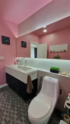 a pink bathroom with a toilet and a sink at Просторная квартира с одной спальней in Kamala Beach