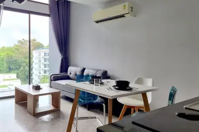 a living room with a couch and a table at Perfect Holiday Spot - Pool View Duplex in Tropical Naiharn! UTL A310 in Rawai Beach