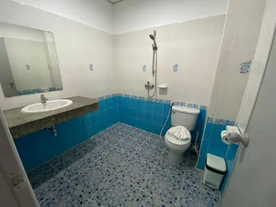 a blue and white bathroom with a toilet and a sink at L&K2023 Residence in Patong Beach