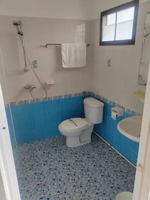 a blue and white bathroom with a toilet and a sink at L&K2023 Residence in Patong Beach
