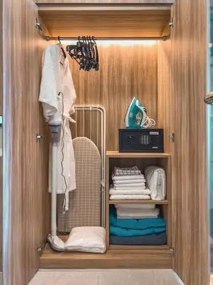 a walk in closet with a wooden wall at 5 Star La Vita Studio Rawai 702 in Phuket Town