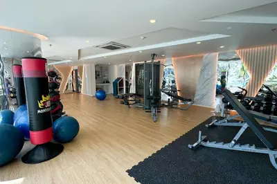 a gym with weights and cardio equipment in a room at 5 Star La Vita Studio Rawai 702 in Phuket Town