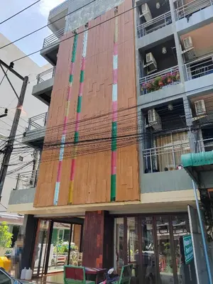 a building with colorful paint on the side of it at Madam Inn Patong in Patong Beach