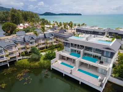 an aerial view of a house on the water at Beachfront 3BR Penthouse with Private Rooftop Pool - Laguna, BangTao in Phuket Town
