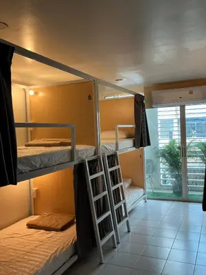two bunk beds in a room with a window at Mawa Anle Hostel in Patong Beach