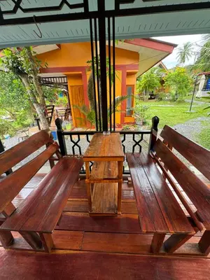 two wooden benches sitting on top of a deck at Baan Suan Sunset in Ban Laem Sai