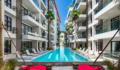 an empty swimming pool in an apartment building at Cozy 1BR Apartment with Big Balcony - 2 Pools & 5 mins from Surin Beach in Phuket Town