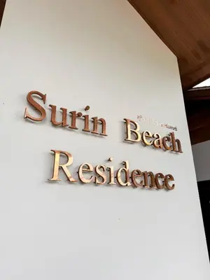 a sign for a beach restaurant on a wall at Cozy 1BR Apartment with Big Balcony - 2 Pools & 5 mins from Surin Beach in Phuket Town