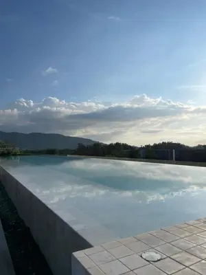 a large pool of water with the sky in the background at Studio Apartment, Bang Tao Phuket in Laguna Phuket