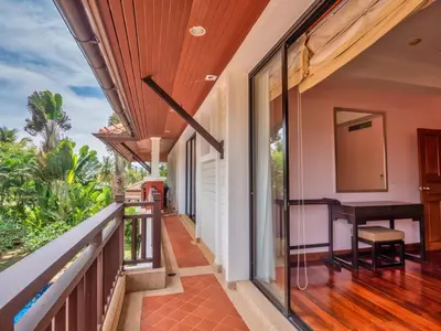 an open balcony with a table and a desk at Happy villa in Laguna in Layan Beach