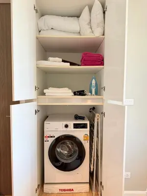 a washer and dryer inside of a closet at Diamond Resort Phuket Condo Bang Tao Beach in Thalang