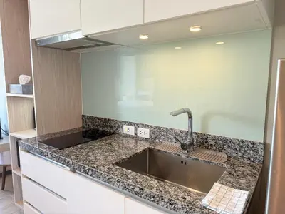 a kitchen with a sink and a counter top at Diamond Resort Phuket Condo Bang Tao Beach in Thalang