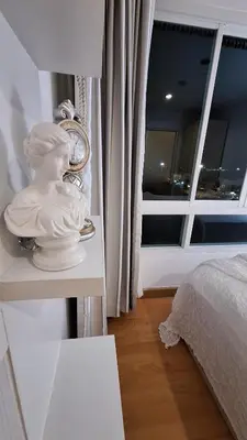a white statue on a table in a bedroom at Plus condo 2 kathu by Tida in Kathu