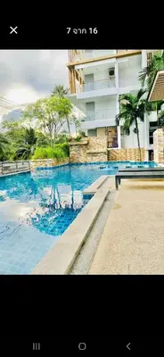 a picture of a swimming pool in front of a building at Plus condo 2 kathu by Tida in Kathu