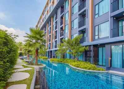 a swimming pool in front of a building at C153 The Aristo Luxury Beach Resort Phuket in Thalang