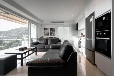 a living room with a couch and a table at ELEGANT Kata sea View Apartmens in Kata Beach
