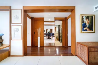 a hallway of a house with wooden doors at Luxury Flat 2BR at CHAVA 5-Star Resort in Surin Beach