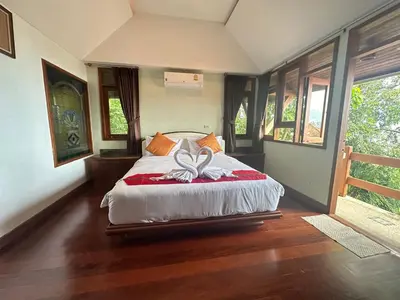 a bedroom with a bed with a bow on it at Villa Moon Talay Panorama View in Patong Beach