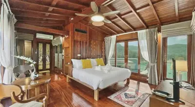 a bedroom with a bed and a ceiling fan at Luxury Seaview 6 Bedrooms with Infinity Pool Villa, private Gym, Superfast WIFI in Surin Beach