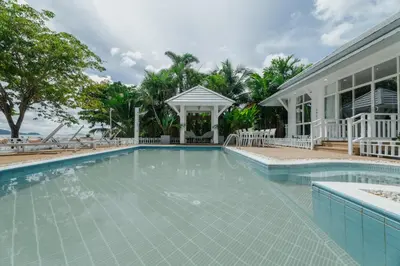 a swimming pool in front of a house with a gazebo at Seaside Bliss Beach Villa Rawai in Rawai Beach
