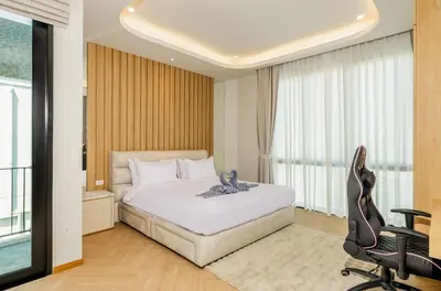 a bedroom with a white bed and a window at Bangtao Pool Villa with Home Cinema - PrymaVista in Phuket