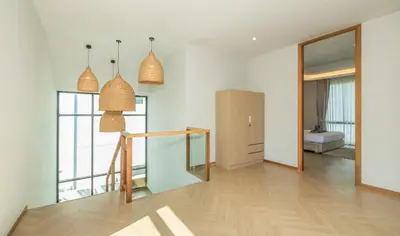 a room with white walls and a wooden floor at Bangtao Pool Villa with Home Cinema - PrymaVista in Phuket