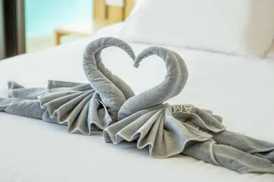 two towels in the shape of a heart on a bed at Bangtao Pool Villa with Home Cinema - PrymaVista in Phuket