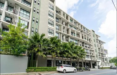 a white car parked in front of a building at 1 bedroom pool view in Bangtao in Thalang