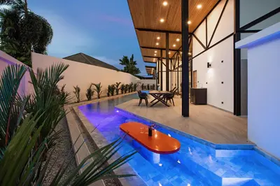 a house with a swimming pool with a wooden table in it at Brand-New 22m Oxygen Pool Villa Sunset Garden 9 in Rawai in Rawai Beach