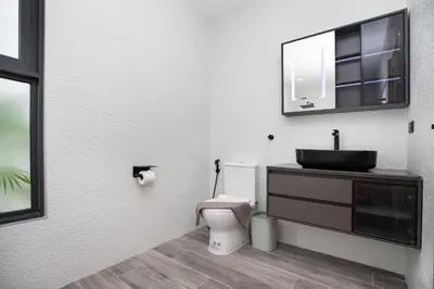 a bathroom with a toilet and a sink and a mirror at Brand-New 22m Oxygen Pool Villa Sunset Garden 9 in Rawai in Rawai Beach