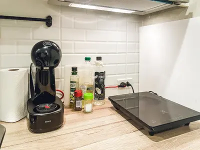 a kitchen counter with a blender and a sink at Apartments pool view in Title Residence Naiyang in Nai Yang Beach