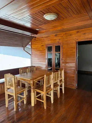 a dining room with a wooden table and chairs at Chaba House Koh Yao Noi in Ban Laem Sai