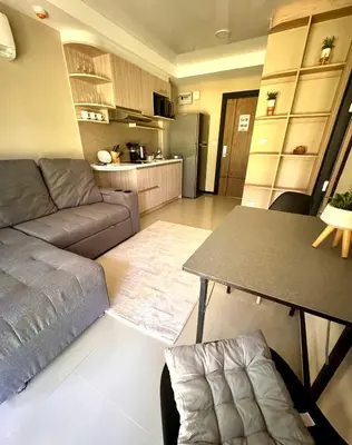 a living room with a couch and a table at NBC апартаменты у пляжа in Rawai Beach