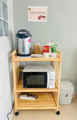a microwave on a cart with a coffee maker at Terminal2 Hotel Phukettown in Phuket Town