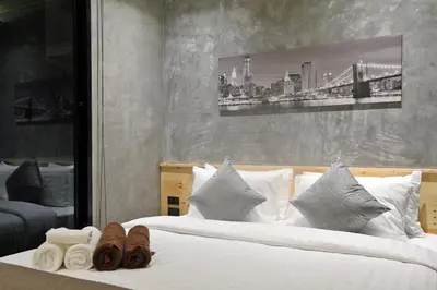 a bedroom with a bed with white sheets and pillows at ReLife The Windy Naiharn in Rawai Beach