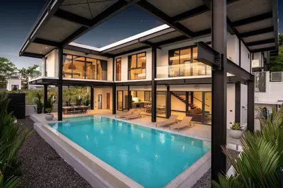 an exterior view of a house with a swimming pool at New & Modern, Loft Style 4BR Villa Sunset Garden 3, 12m Salt Pool, just 10min drive Naiharn Beach in Rawai Beach