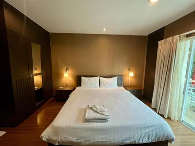 a bedroom with a large bed with two towels on it at Luxury Villa Patong in Patong Beach