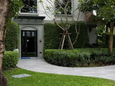 a front door of a house with a tree at The Title Residences Apartment 7 min walk to Nai Yang Beach in Nai Yang Beach