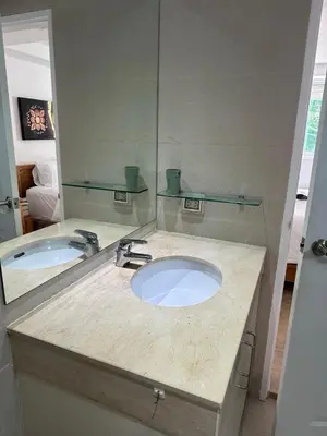 a bathroom with a sink and a mirror at Ocean View Residences! in Phuket Town