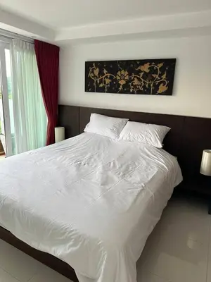 a bedroom with a large bed with white sheets at Ocean View Residences! in Karon Beach