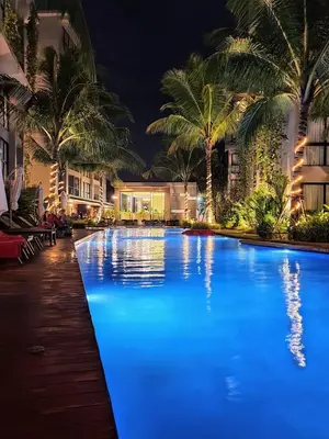 a large swimming pool with blue lights in a resort at Diamond Resort in Bang Tao Beach