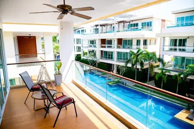 an apartment balcony with a pool and a ceiling fan at Krabi One Bedroom Pool View in Klong Muang Beach