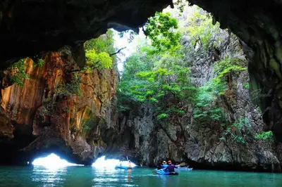 a group of people kayaking in a cave at West facing 3br Boutique Pool Villa in Phuket Town