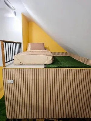 a bed sitting on a wooden platform in a room at Baibon 4 Homestay Thalang Phuke in Thalang