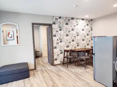 a dining room with a table and a floral wallpaper at Title Residencies Naiyang 2 Bedrooms PoolAccess in Nai Yang Beach